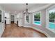Dining area with hardwood floors, a modern chandelier, and views of the pool at 858 Pates Creek Rd, Stockbridge, GA 30281