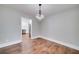 Dining room featuring hardwood floors and a decorative chandelier adjacent to the kitchen at 858 Pates Creek Rd, Stockbridge, GA 30281