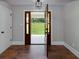 Inviting foyer with rich hardwood floors and an open view to a spacious green lawn and the home's exterior at 858 Pates Creek Rd, Stockbridge, GA 30281