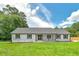 Charming single-story home with a covered front porch, shutters, and lush front lawn at 858 Pates Creek Rd, Stockbridge, GA 30281