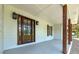 Charming front porch showcasing a beautiful wooden door, complemented by stylish lanterns and rustic wood posts at 858 Pates Creek Rd, Stockbridge, GA 30281