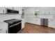 Stylish kitchen featuring white subway tile backsplash, white cabinetry, stainless steel appliances, and hardwood floors at 858 Pates Creek Rd, Stockbridge, GA 30281