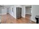 Chic kitchen boasts white cabinets, hardwood floors, and stainless steel appliances, creating a seamless flow into the dining area at 858 Pates Creek Rd, Stockbridge, GA 30281