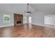 Bright living room with hardwood floors, stone fireplace, and a ceiling fan offering comfort and style at 858 Pates Creek Rd, Stockbridge, GA 30281