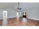 Open living room with hardwood floors, neutral paint, vaulted ceiling, and natural light streaming in through large windows at 858 Pates Creek Rd, Stockbridge, GA 30281