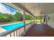 Inviting covered deck overlooks a sparkling pool, perfect for outdoor entertaining and relaxation in a private backyard setting at 858 Pates Creek Rd, Stockbridge, GA 30281