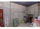 Unfinished basement corner with exposed beams, concrete wall, and miscellaneous storage items at 1404 Fairwinds Ct, Loganville, GA 30052