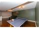 Spacious finished basement includes a ping pong table and a projector screen for entertainment at 1404 Fairwinds Ct, Loganville, GA 30052