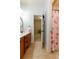 Bathroom with cherry-themed shower curtain and tile floors connecting to bedroom at 1404 Fairwinds Ct, Loganville, GA 30052