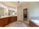 Luxurious bathroom with double vanity, soaking tub, and access to walk-in closet at 1404 Fairwinds Ct, Loganville, GA 30052