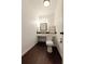 Bathroom with modern dark brown wood-look floors, white walls and vanity at 1404 Fairwinds Ct, Loganville, GA 30052