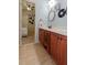 Bathroom with cherry cabinets, tile floors, and a doorway to the bedroom at 1404 Fairwinds Ct, Loganville, GA 30052
