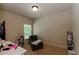 Bedroom with comfy chair, bright window, neutral walls, and carpet at 1404 Fairwinds Ct, Loganville, GA 30052
