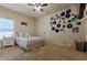 Cozy bedroom featuring carpet, a ceiling fan, and unique vinyl record decorations on the walls at 1404 Fairwinds Ct, Loganville, GA 30052