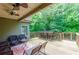 Spacious covered deck with outdoor bar seating, creating an ideal space for socializing and enjoying the natural surroundings at 1404 Fairwinds Ct, Loganville, GA 30052