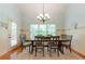 Elegant dining room with large windows and seating for six at 1404 Fairwinds Ct, Loganville, GA 30052