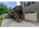 Charming home with a convenient two-car garage and spacious elevated wooden deck with steps to the driveway at 1404 Fairwinds Ct, Loganville, GA 30052