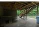Lower patio of the home showing wood deck supports, a dog house and partial lawn area at 1404 Fairwinds Ct, Loganville, GA 30052