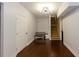 Neutral hallway features hardwood floors and a modern sputnik light fixture at 1404 Fairwinds Ct, Loganville, GA 30052