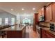 Open kitchen with granite countertops and stainless steel appliances overlooks dining area and living room at 1404 Fairwinds Ct, Loganville, GA 30052