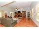 Open-concept living room features a stone fireplace, built-in shelving, hardwood floors, and large windows for natural light at 1404 Fairwinds Ct, Loganville, GA 30052