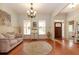 Inviting living room showcasing hardwood floors, detailed trim, and a stylish chandelier; perfect for elegant gatherings at 1404 Fairwinds Ct, Loganville, GA 30052