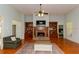 Bright and airy living room featuring a fireplace, hardwood floors, and access to the kitchen and bedrooms at 1404 Fairwinds Ct, Loganville, GA 30052
