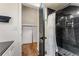 Modern bathroom featuring a sleek black marble tiled shower and storage shelves at 1471 Hardin Dr, College Park, GA 30337