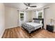 Bedroom featuring a ceiling fan, hardwood floors, and a bed with a checkered blanket at 1471 Hardin Dr, College Park, GA 30337