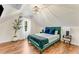 Cozy bedroom with a vaulted ceiling, stylish chandelier, and elegant emerald green bed frame and accent blanket at 1471 Hardin Dr, College Park, GA 30337