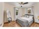 Bright bedroom featuring wood floors, two windows, and a bed with stylish gray accents at 1471 Hardin Dr, College Park, GA 30337