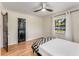 Bright bedroom featuring hardwood floors, black doors, and a bed with checkered blanket at 1471 Hardin Dr, College Park, GA 30337