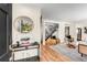 Inviting foyer featuring elegant console table, mirror, modern staircase, and hardwood floors at 1471 Hardin Dr, College Park, GA 30337