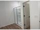 Modern bathroom featuring a glass-enclosed shower with built-in shelving and neutral flooring at 3232 Cyrus Creek Dr, Kennesaw, GA 30152