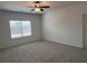 Bright bedroom with a ceiling fan, neutral carpet, and natural light from a large window at 3232 Cyrus Creek Dr, Kennesaw, GA 30152