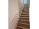 Light-filled staircase featuring light wood steps, white risers, and a contemporary white handrail at 3232 Cyrus Creek Dr, Kennesaw, GA 30152