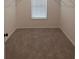 Spacious walk-in closet with neutral carpet, window, and shelving ready for customization at 3232 Cyrus Creek Dr, Kennesaw, GA 30152