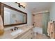 Well-lit bathroom with framed mirror, granite countertop and shower-tub combo at 825 Chalet Hls, Mcdonough, GA 30253