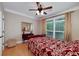 This bedroom features hardwood floors, a window, and decorative mirror at 825 Chalet Hls, Mcdonough, GA 30253