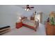 Comfortable bedroom with wood furniture, soft lighting and a ceiling fan at 825 Chalet Hls, Mcdonough, GA 30253
