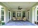 Inviting covered patio featuring a seating area, ceiling fan, and views of the landscaped backyard at 825 Chalet Hls, Mcdonough, GA 30253