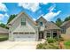 Charming home featuring a two-car garage, stone accents, manicured landscaping, and inviting curb appeal at 825 Chalet Hls, Mcdonough, GA 30253