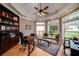 This home office features a bay window, beautiful trim and molding, and built in shelving at 825 Chalet Hls, Mcdonough, GA 30253