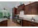 Beautiful kitchen with stone countertops, dark wood cabinetry, and stainless appliances at 825 Chalet Hls, Mcdonough, GA 30253