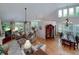 Open-concept living and dining area with large windows and hardwood floors at 825 Chalet Hls, Mcdonough, GA 30253