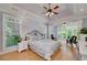 The main bedroom features a tray ceiling, a ceiling fan, many windows, and an attached sitting area at 825 Chalet Hls, Mcdonough, GA 30253