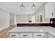 Bright kitchen featuring white cabinets, quartz countertops, modern pendants, and stainless appliances at 583 Whitaker St, Atlanta, GA 30318