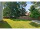 A sprawling backyard is enclosed by a classic wooden fence, creating a private and serene outdoor space at 5831 Wembley Dr, Douglasville, GA 30135