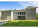Back of home showing lawn, a screened in porch and multi-car garage at 5831 Wembley Dr, Douglasville, GA 30135