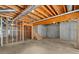 Unfinished basement space with a staircase, concrete floor, and exposed ceiling at 5831 Wembley Dr, Douglasville, GA 30135